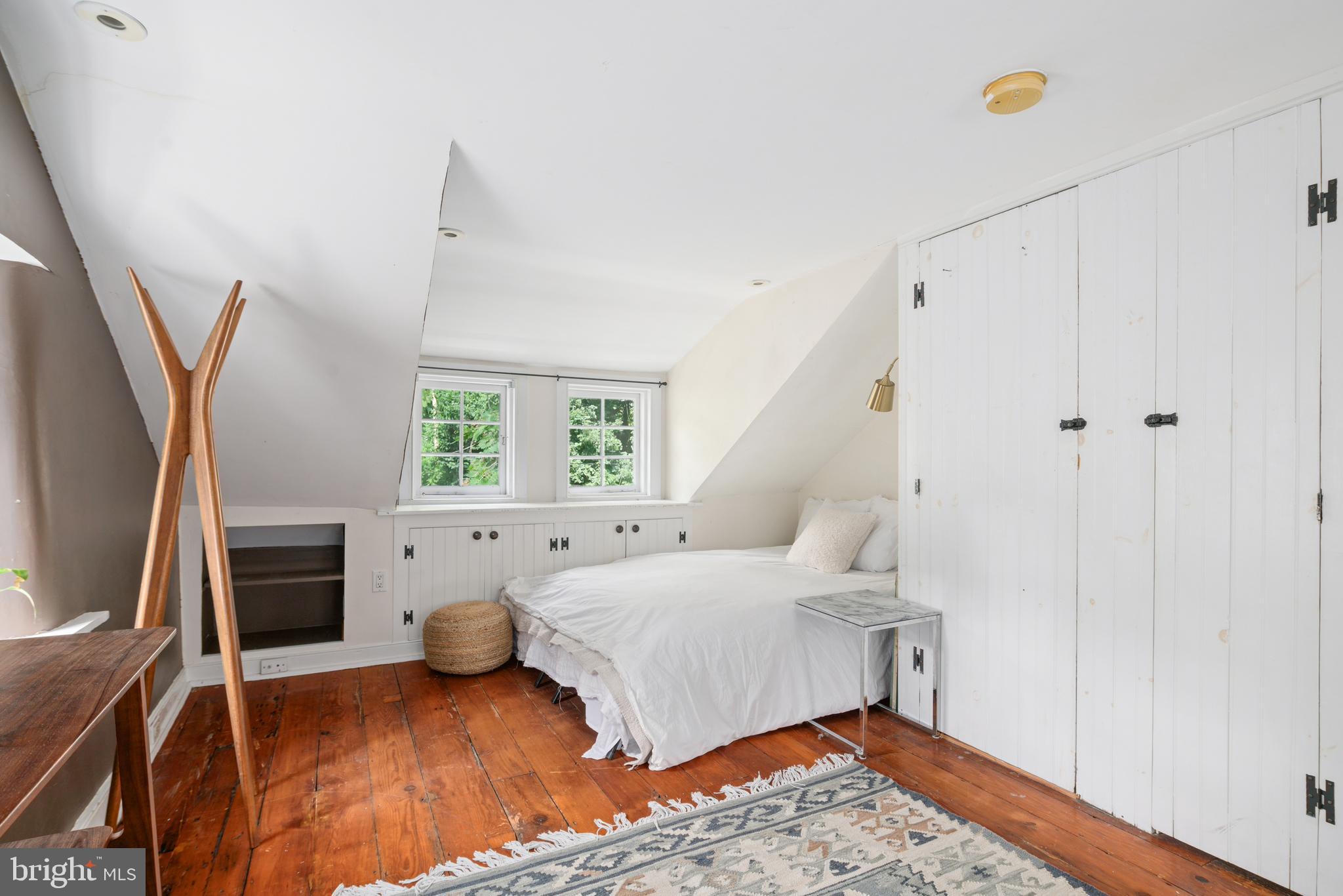 75 West Rose Valley Road Rose Valley, PA 19086 - Photo 24 of 31 a bedroom with a bed and wooden floor