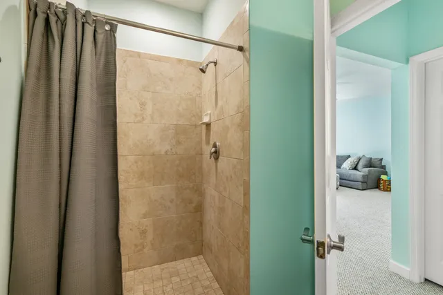a bathroom with a shower and a glass door