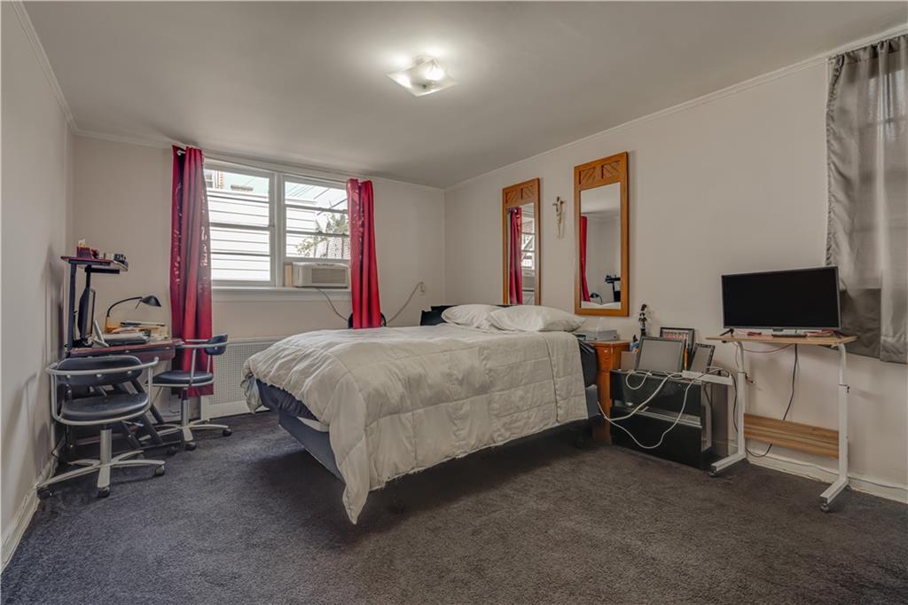 623 Ave Y Brooklyn, NY 11235 - Photo 16 of 24 a bedroom with a bed and a flat tv screen on the dresser