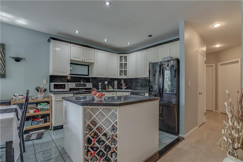 623 Ave Y Brooklyn, NY 11235 - Photo 7 of 24 a kitchen with stainless steel appliances granite countertop a sink stove and refrigerator