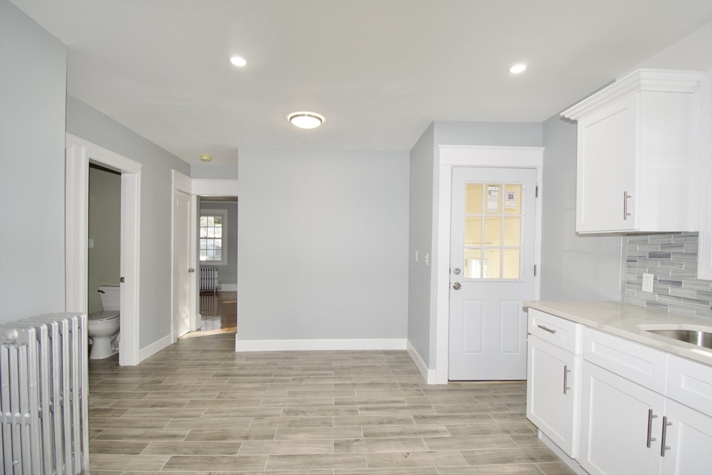 158 Gilbert Avenue Springfield, MA 01119 - Photo 11 of 30 a view of a kitchen with a sink and dishwasher with wooden floor
