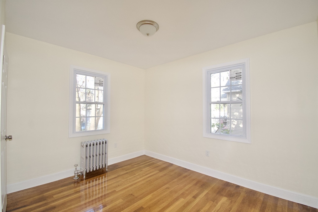 158 Gilbert Avenue Springfield, MA 01119 - Photo 12 of 30 an empty room with wooden floor and windows