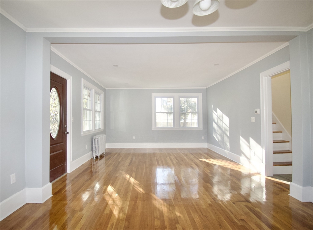 158 Gilbert Avenue Springfield, MA 01119 - Photo 5 of 30 a view of empty room with wooden floor and fan
