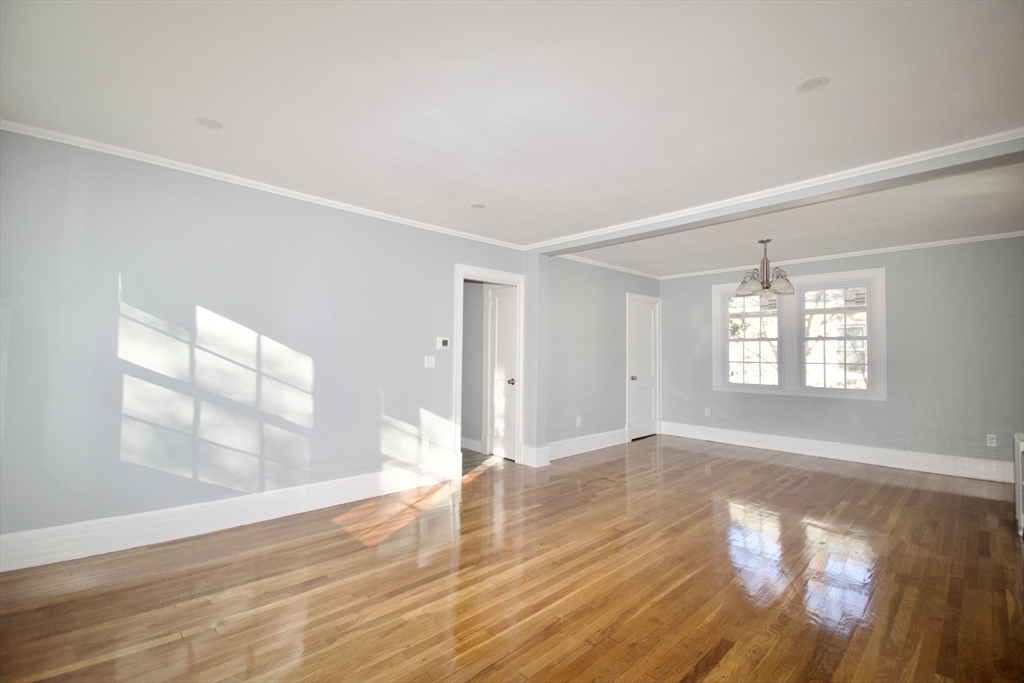 158 Gilbert Avenue Springfield, MA 01119 - Photo 6 of 30 an empty room with wooden floor and windows