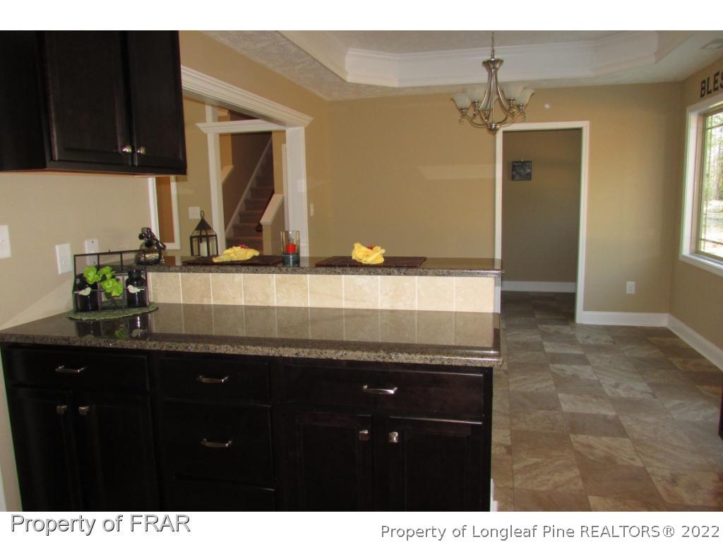 3341 Thrower Road Hope Mills, NC 28348 - Photo 13 of 32 a bathroom with a granite countertop sink a mirror and cabinets