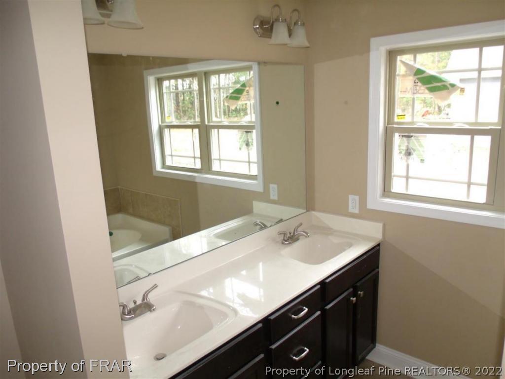 3341 Thrower Road Hope Mills, NC 28348 - Photo 15 of 32 a bathroom with a sink and a bathtub