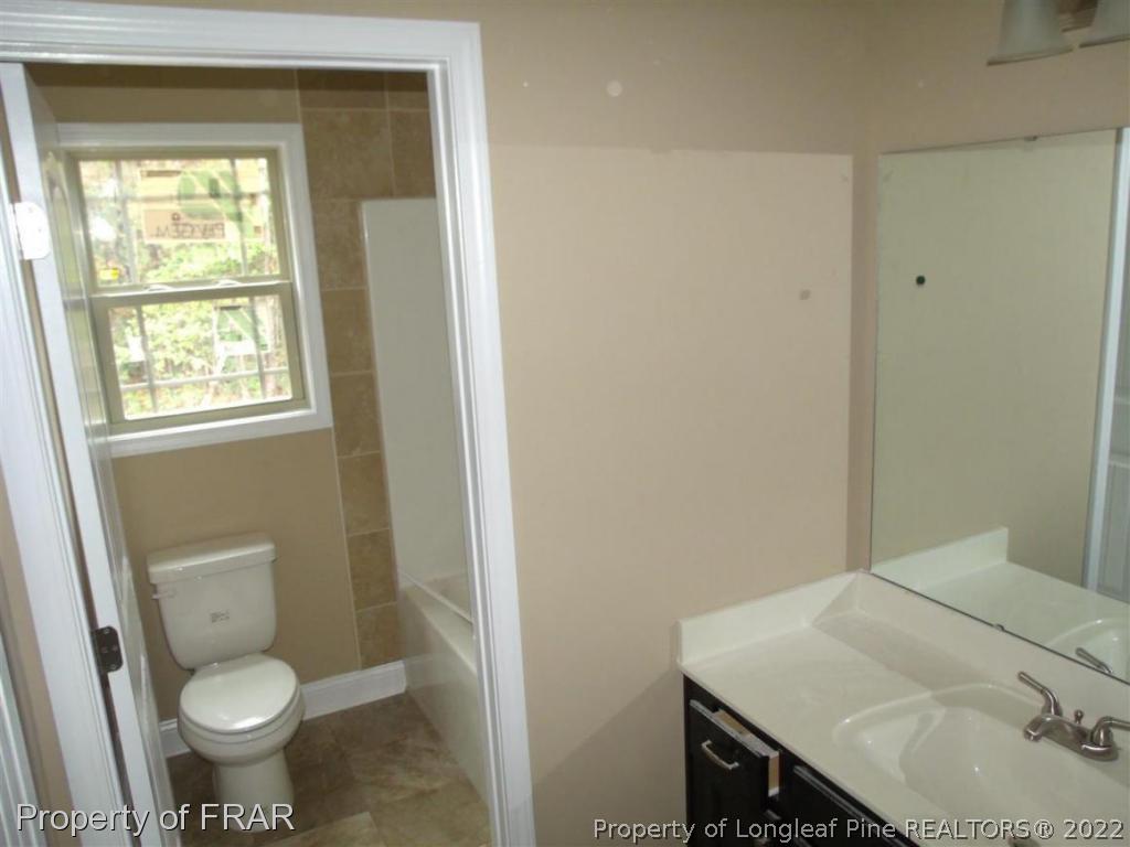 3341 Thrower Road Hope Mills, NC 28348 - Photo 17 of 32 a bathroom with a sink toilet and window
