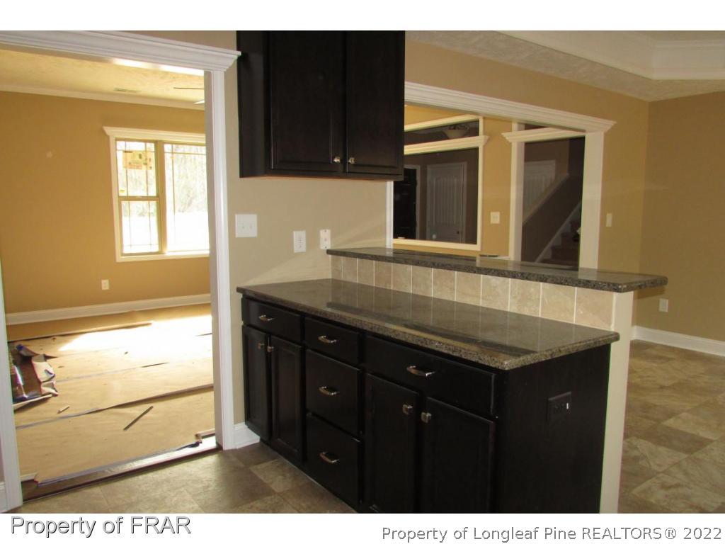3341 Thrower Road Hope Mills, NC 28348 - Photo 19 of 32 a kitchen with a sink a stove and window
