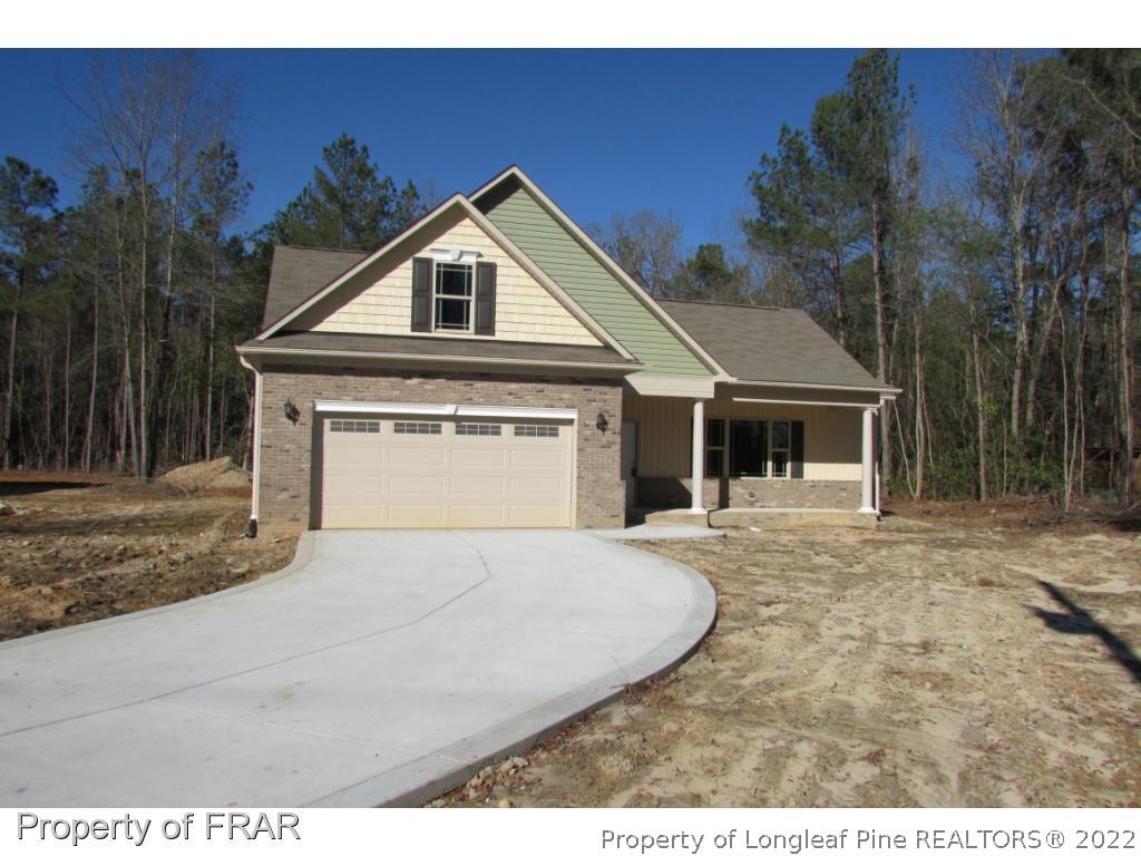 3341 Thrower Road Hope Mills, NC 28348 - Photo 2 of 32 a front view of a house with a yard