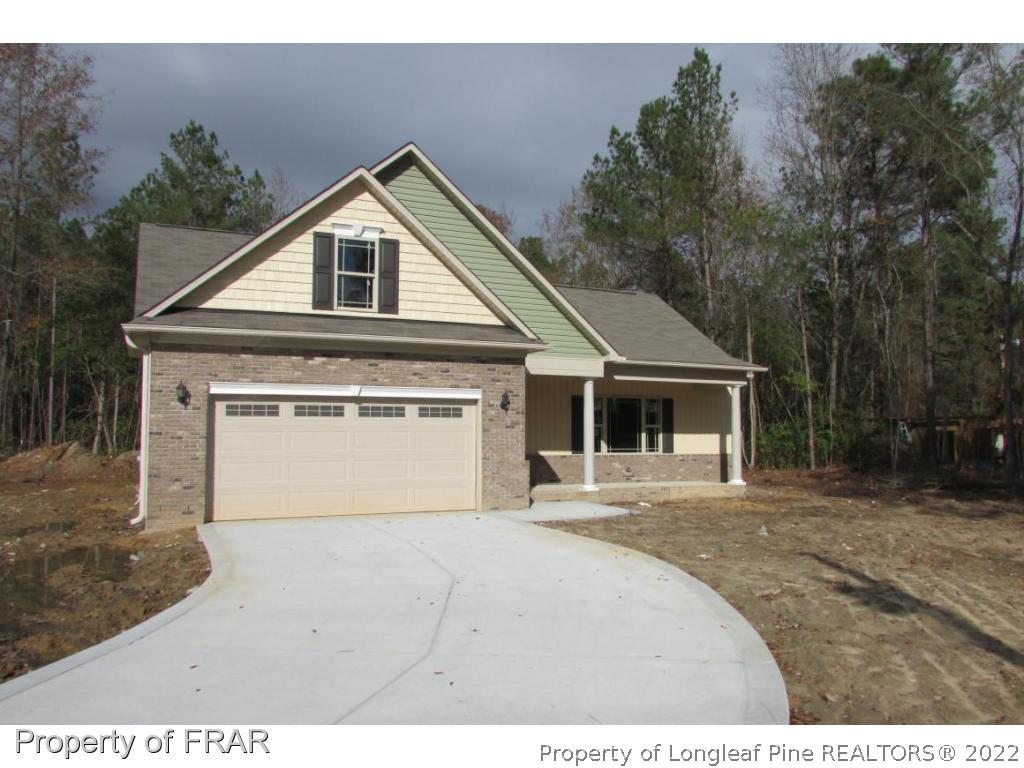 3341 Thrower Road Hope Mills, NC 28348 - Photo 25 of 32 a front view of a house with a yard