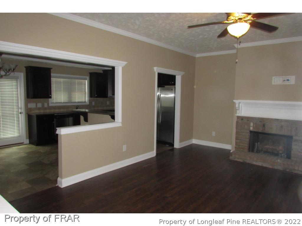 3341 Thrower Road Hope Mills, NC 28348 - Photo 7 of 32 a view of a livingroom with wooden floor and kitchen space