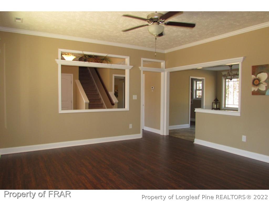 3341 Thrower Road Hope Mills, NC 28348 - Photo 8 of 32 a view of an empty room with wooden floor and a ceiling fan