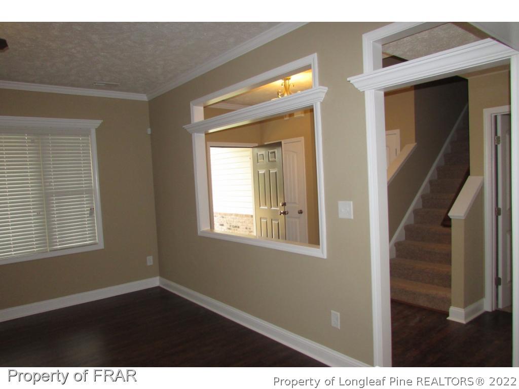 3341 Thrower Road Hope Mills, NC 28348 - Photo 10 of 32 a view of an empty room with wooden floor and a window