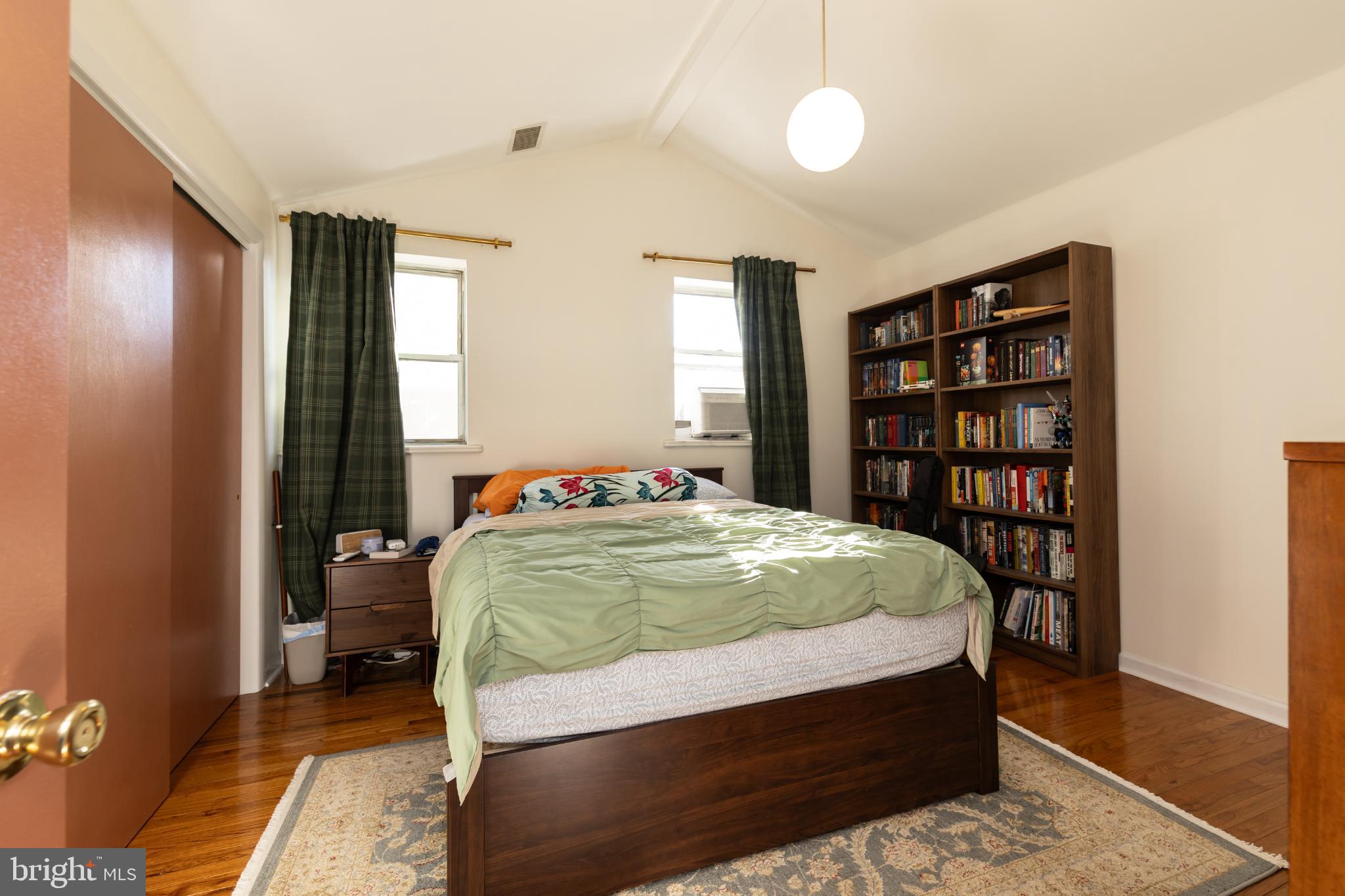 910 Mountain Street Philadelphia, PA 19148 - Photo 16 of 31 a bedroom with a large bed and a book shelf