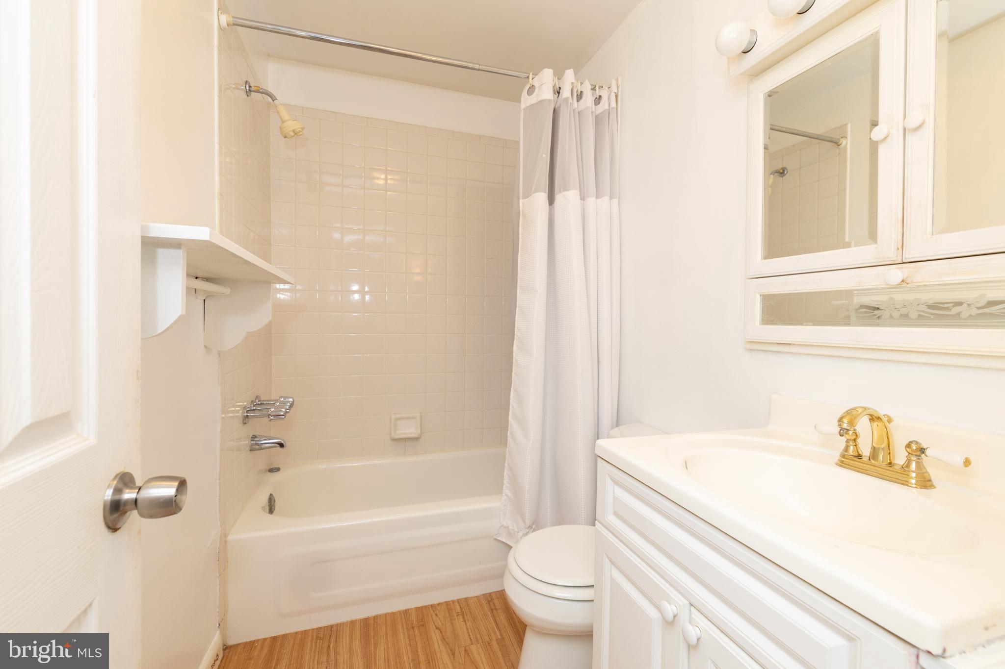 910 Mountain Street Philadelphia, PA 19148 - Photo 6 of 31 a bathroom with a bathtub shower sink vanity and a toilet