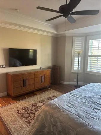 a bedroom with a bed and a television