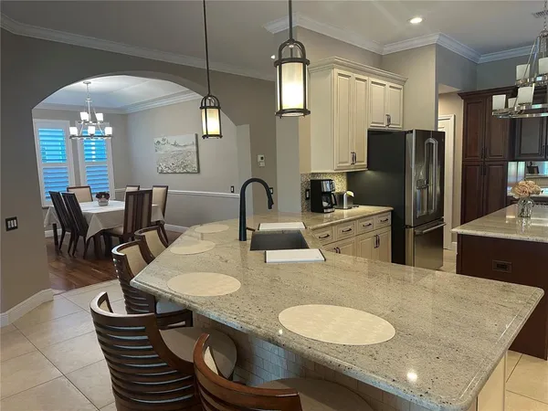 a kitchen with sink and refrigerator