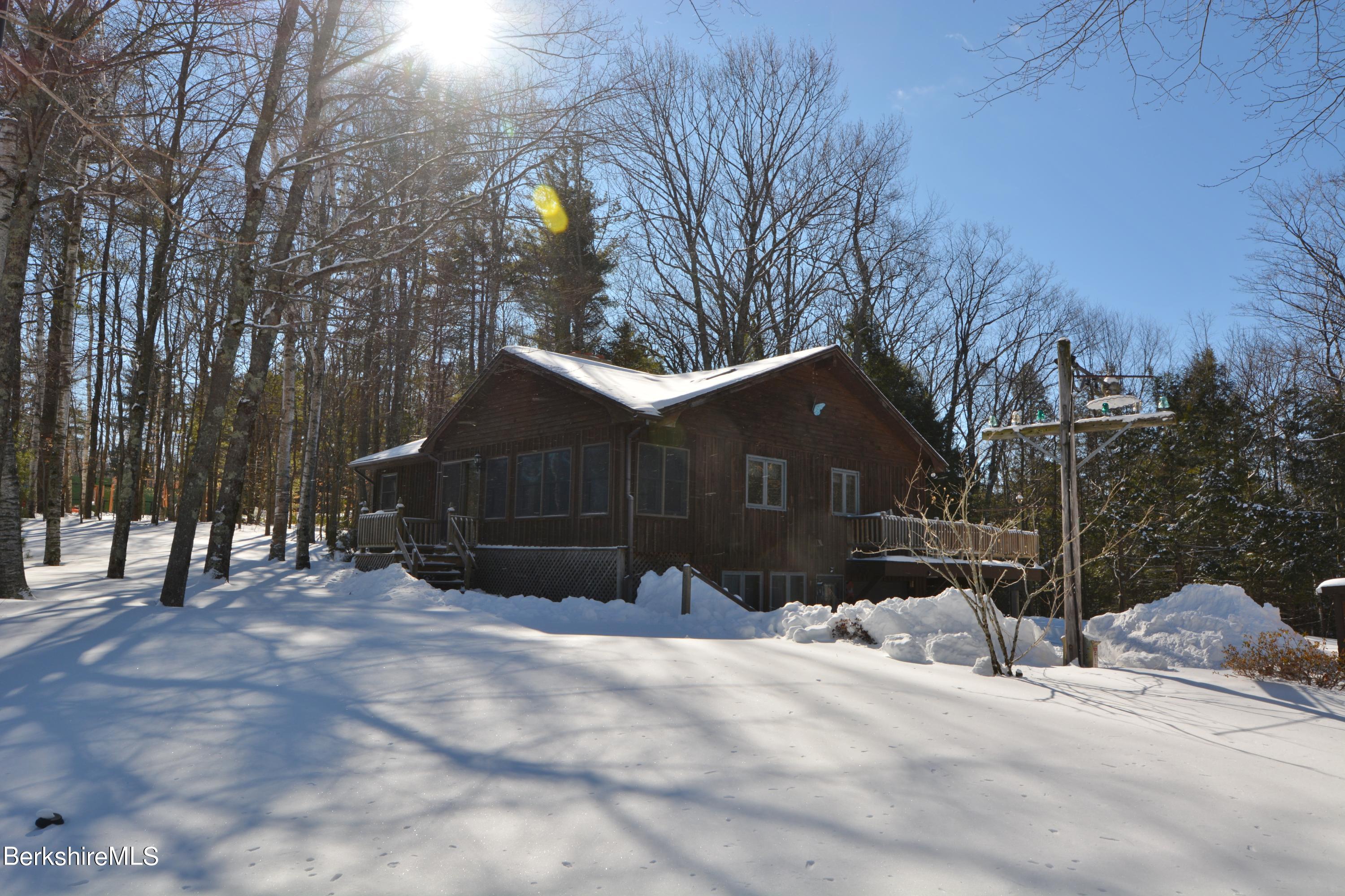106 Pine Road Otis, MA 01029 - Photo 1 of 19 a street view covered with snow