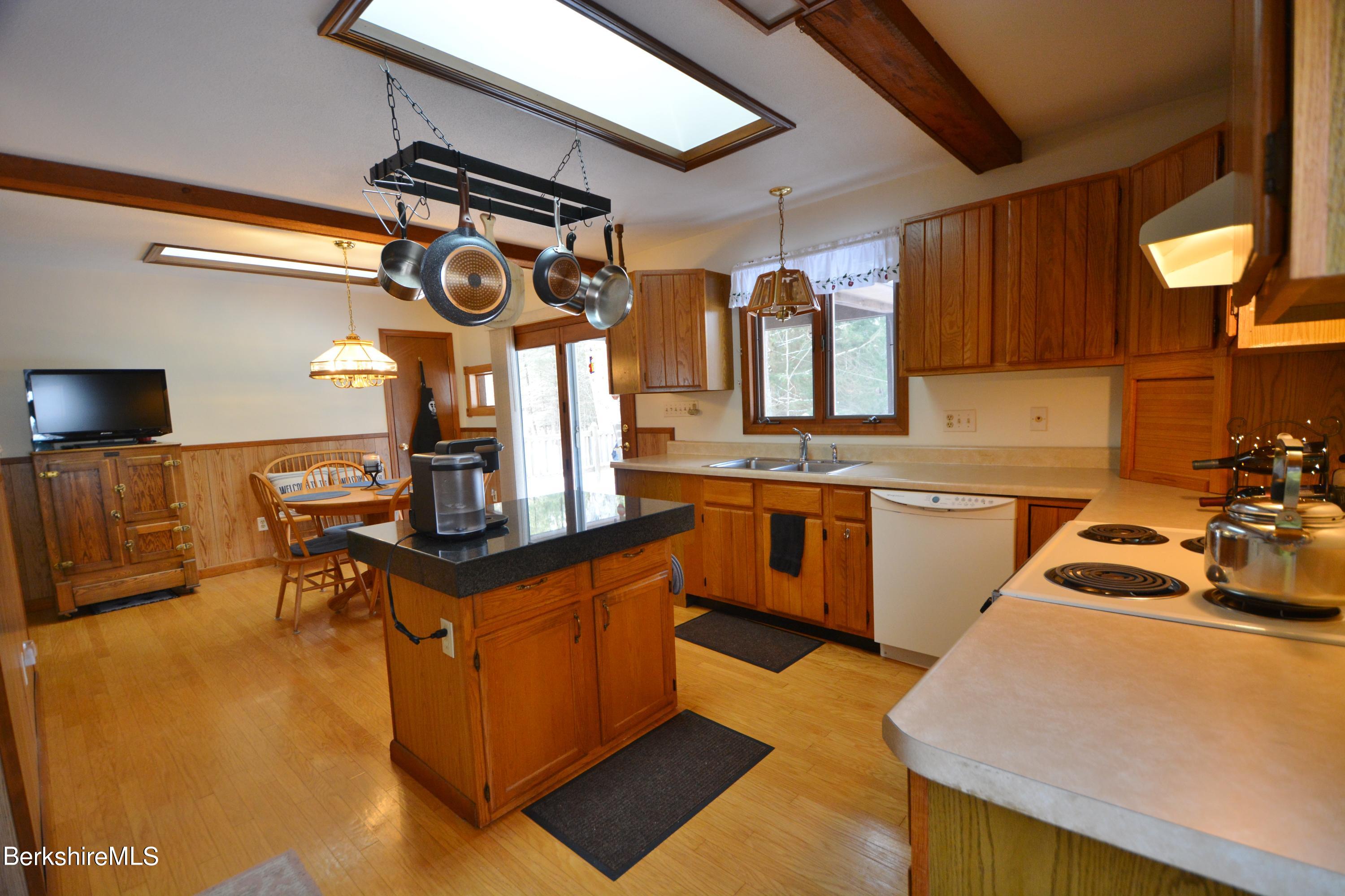106 Pine Road Otis, MA 01029 - Photo 3 of 19 a kitchen with stainless steel appliances granite countertop a sink a stove and a refrigerator