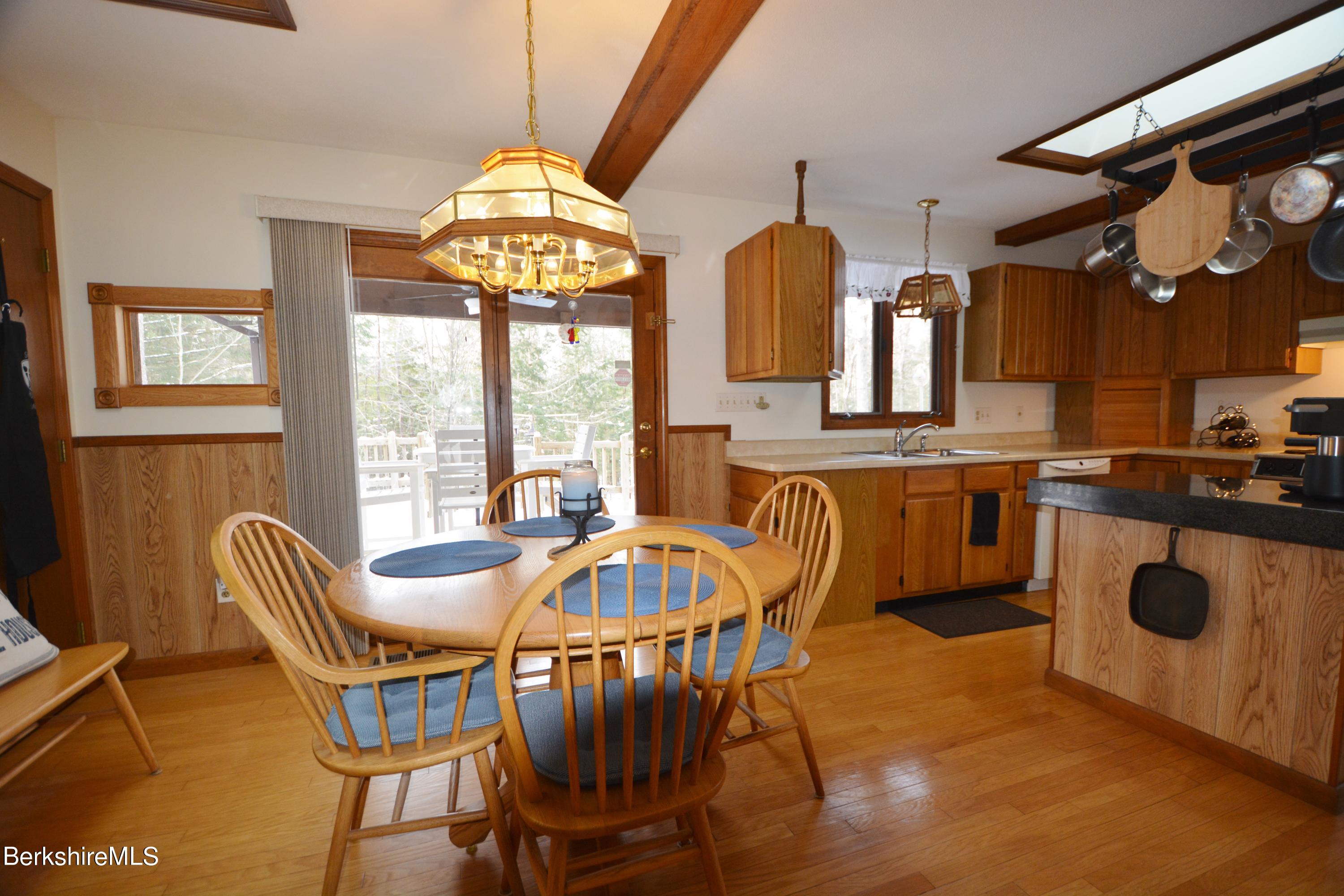 106 Pine Road Otis, MA 01029 - Photo 4 of 19 a dining room with furniture and a chandelier
