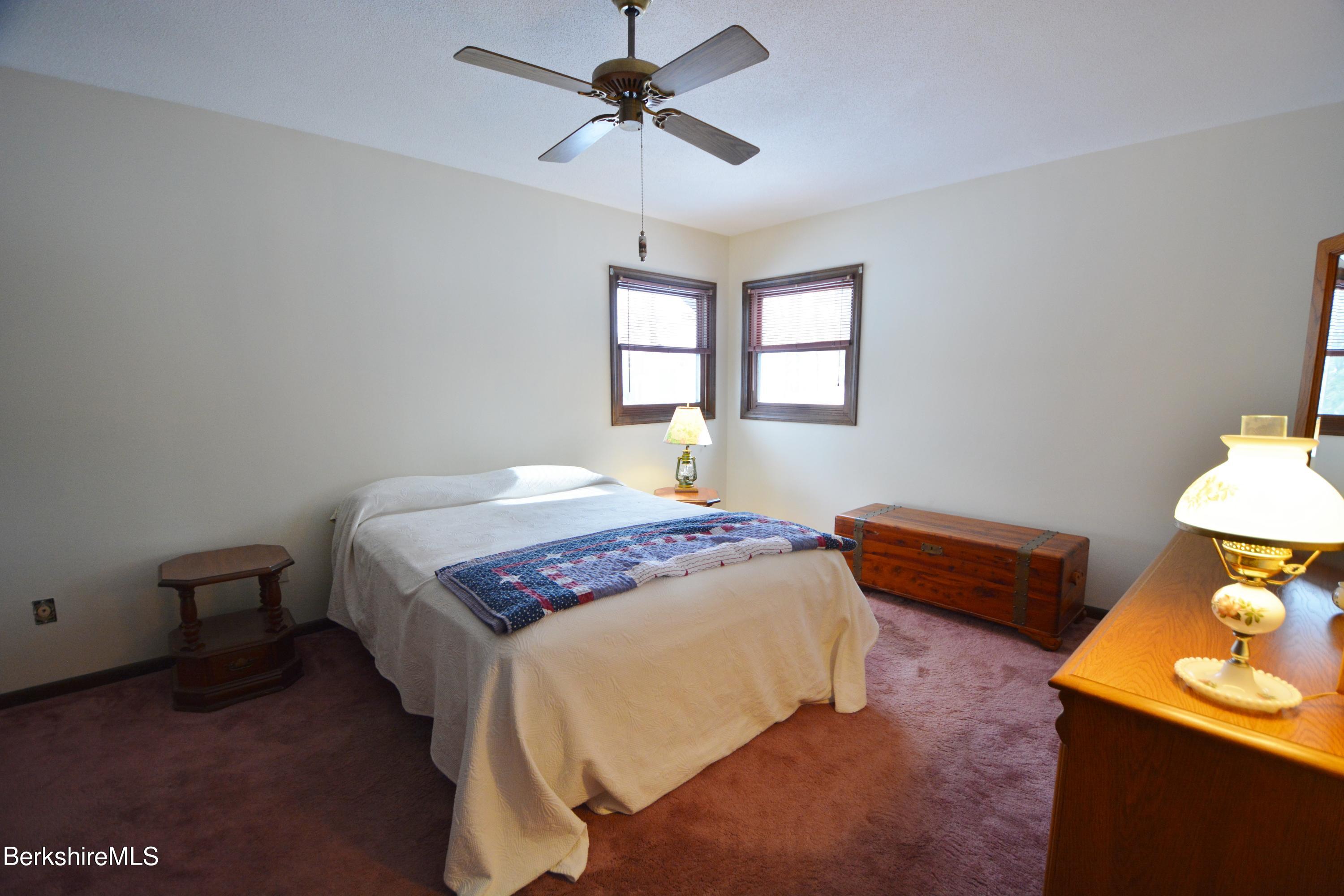 106 Pine Road Otis, MA 01029 - Photo 9 of 19 a bedroom with a bed and a lamp on dresser