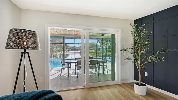 a very nice looking room with a large window and wooden floor