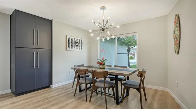 a view of a dining room with furniture and chandelier