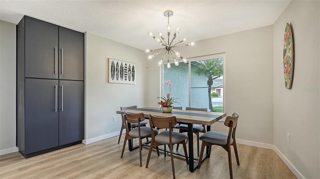 3924 Helene Street Sarasota, FL 34233 - Photo 14 of 53 a view of a dining room with furniture and chandelier