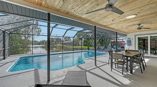 a view of a patio with table and chairs potted plants with wooden floor