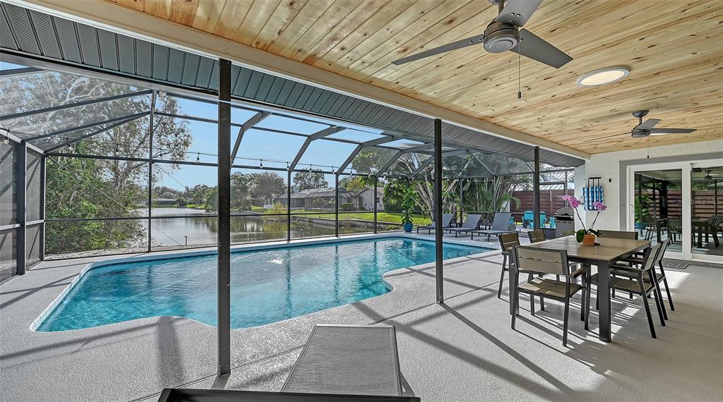 3924 Helene Street Sarasota, FL 34233 - Photo 15 of 53 a view of a patio with table and chairs potted plants with wooden floor