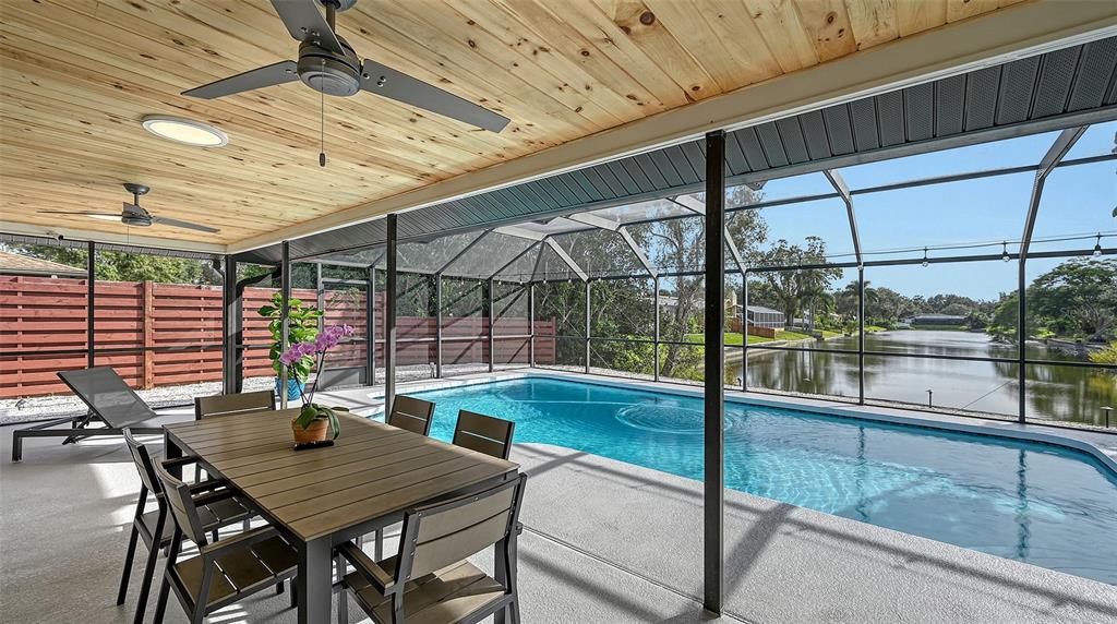 3924 Helene Street Sarasota, FL 34233 - Photo 16 of 53 a view of a patio with table and chairs with wooden floor