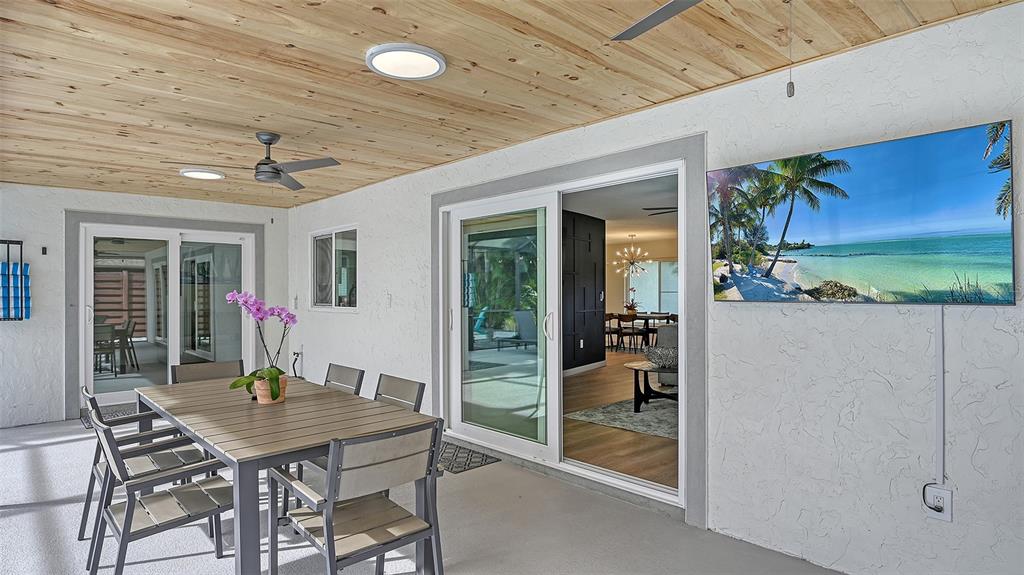 3924 Helene Street Sarasota, FL 34233 - Photo 17 of 53 a view of a patio with table and chairs