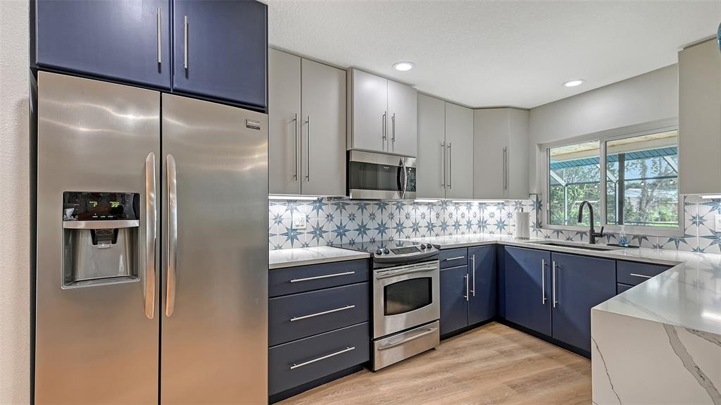 3924 Helene Street Sarasota, FL 34233 - Photo 20 of 53 a kitchen with stainless steel appliances granite countertop a refrigerator and a sink