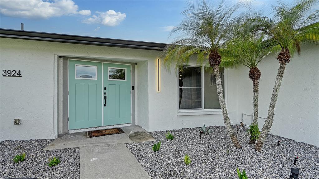 3924 Helene Street Sarasota, FL 34233 - Photo 2 of 53 a front view of a house with garden