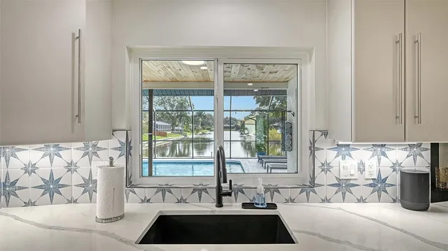 a view of a sink and a window with couch