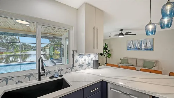 a kitchen with a sink and large window