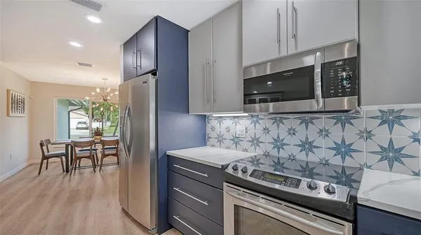 a kitchen with stainless steel appliances granite countertop a stove and a refrigerator