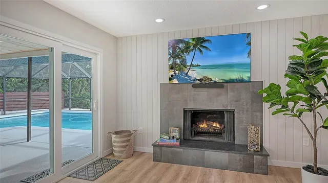 a living room with a fireplace and a potted plant