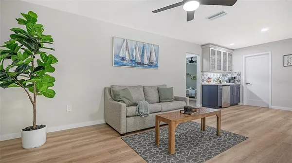 a living room with furniture and a potted plant