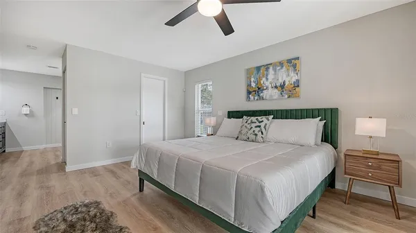 a bedroom with a bed and a painting on the wall