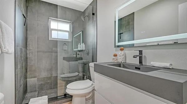 a bedroom with a bed and a lamp