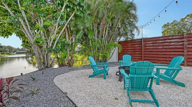 a view of an ocean with boats and trees all around