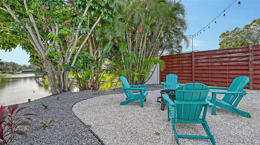 3924 Helene Street Sarasota, FL 34233 - Photo 49 of 53 a backyard of a house with barbeque oven table and chairs