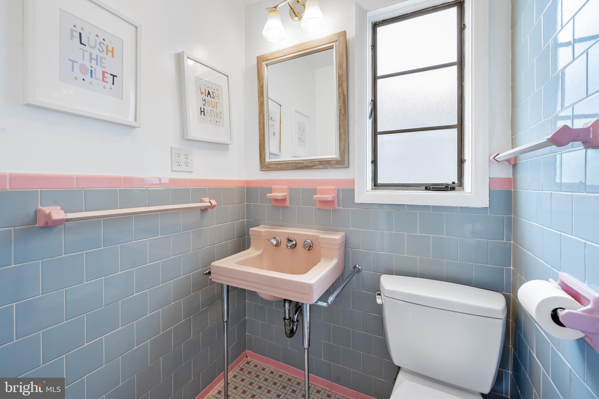 630 Dunkirk Road Baltimore, MD 21212 - Photo 14 of 36 a bathroom with a sink a toilet and a mirror