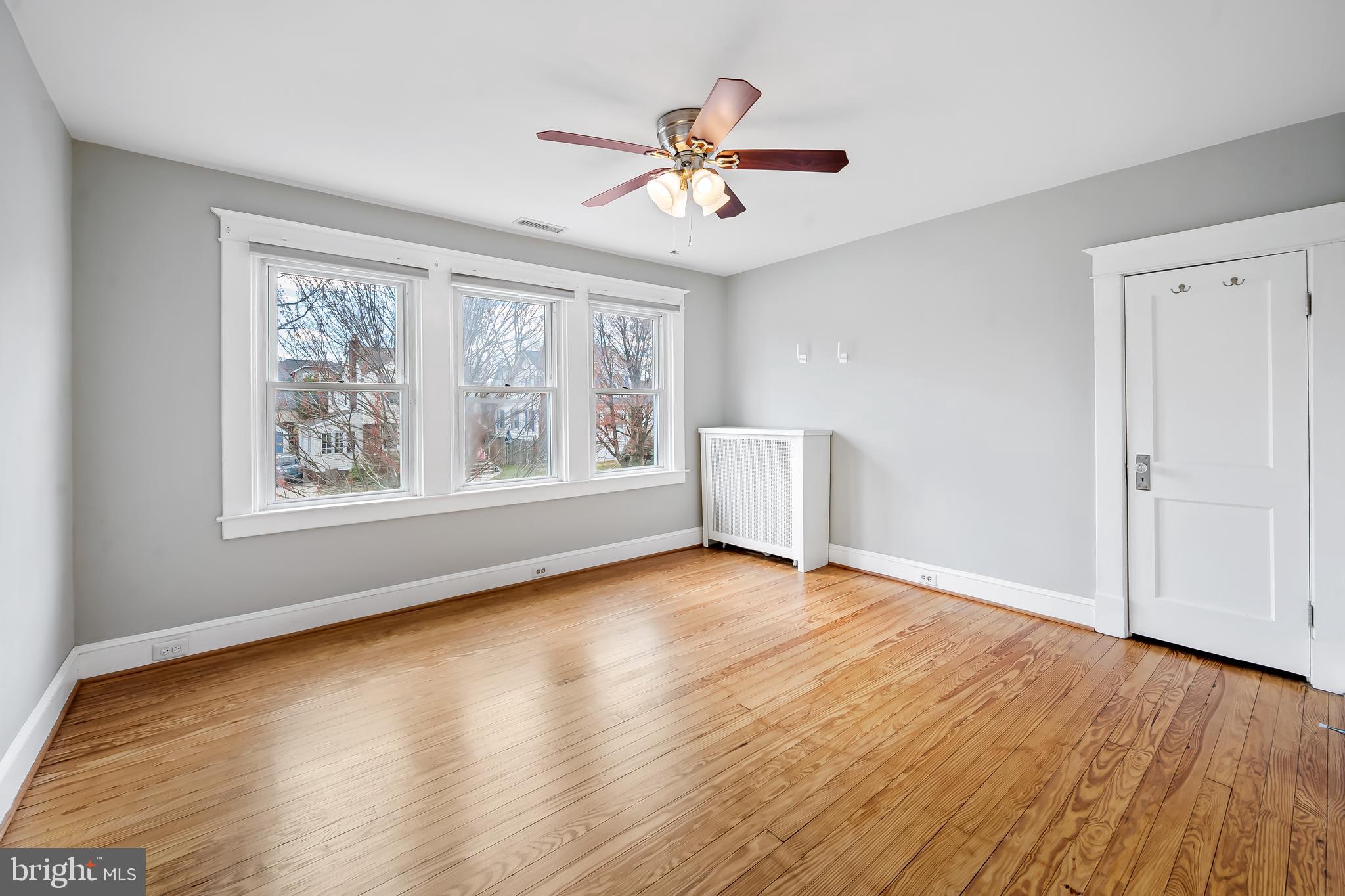 630 Dunkirk Road Baltimore, MD 21212 - Photo 17 of 36 a view of an empty room with wooden floor and a window
