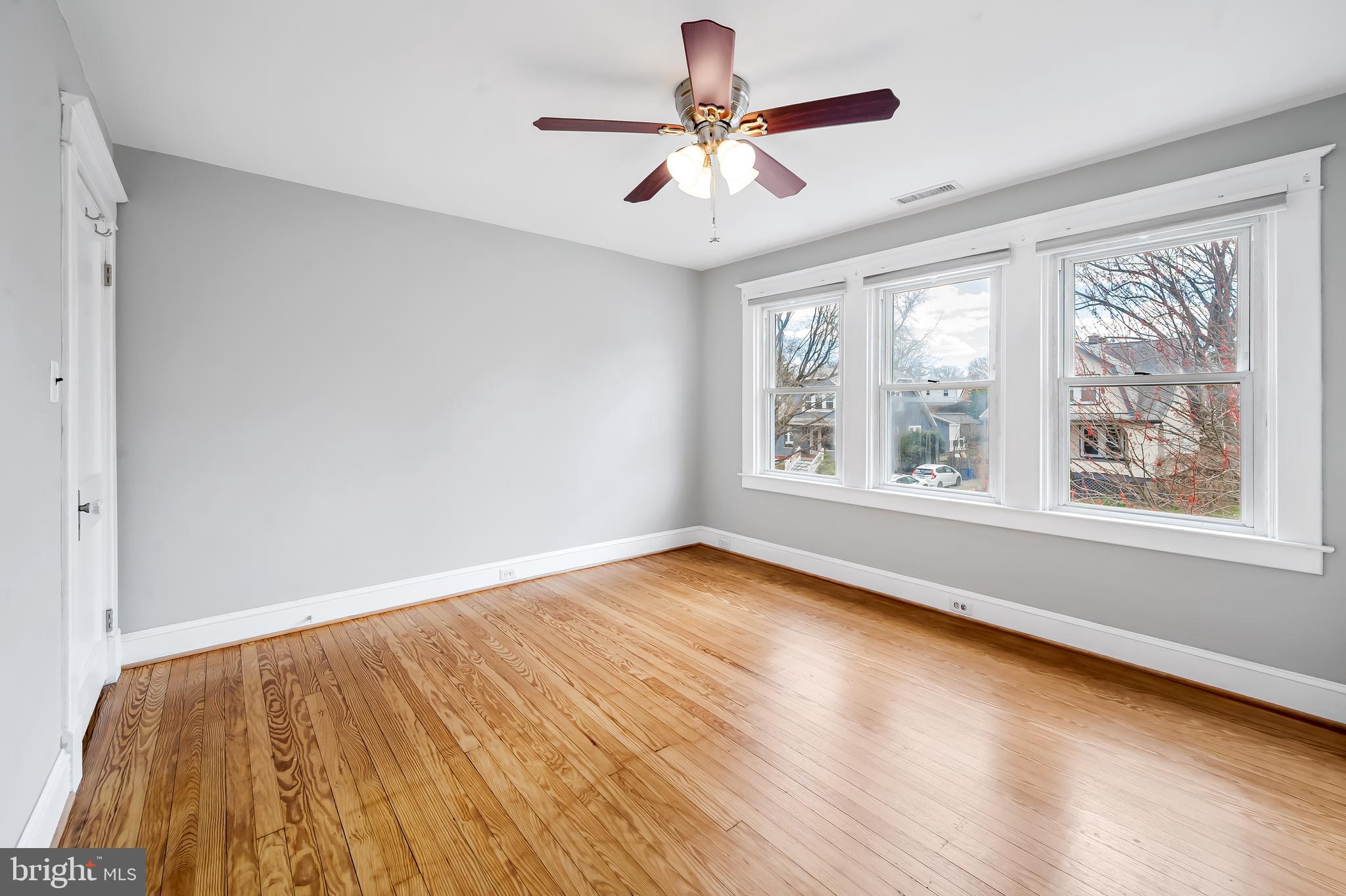 630 Dunkirk Road Baltimore, MD 21212 - Photo 18 of 36 wooden floor in an empty room with a window