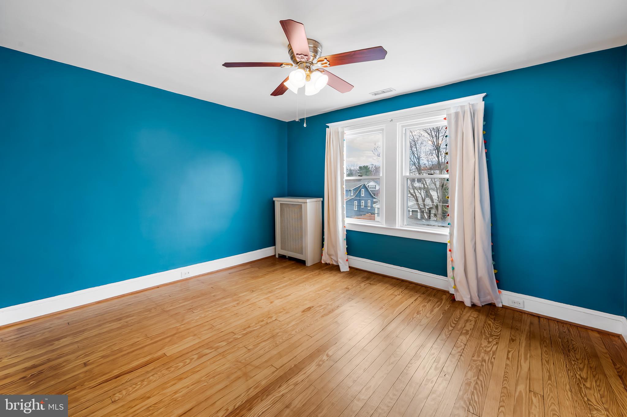 630 Dunkirk Road Baltimore, MD 21212 - Photo 19 of 36 a view of an empty room with a window and wooden floor