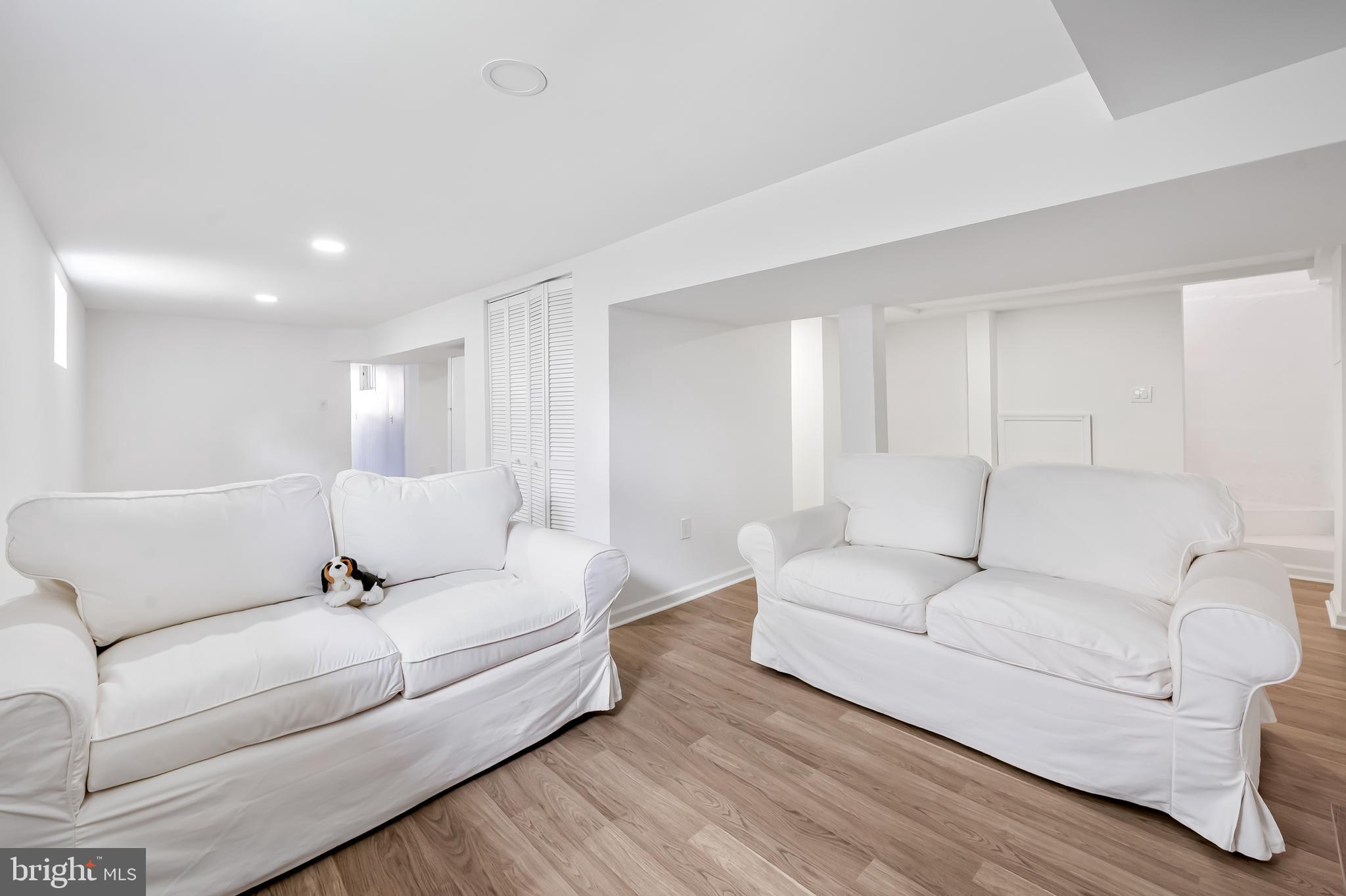 630 Dunkirk Road Baltimore, MD 21212 - Photo 27 of 36 a living room with furniture white walls and wooden floor