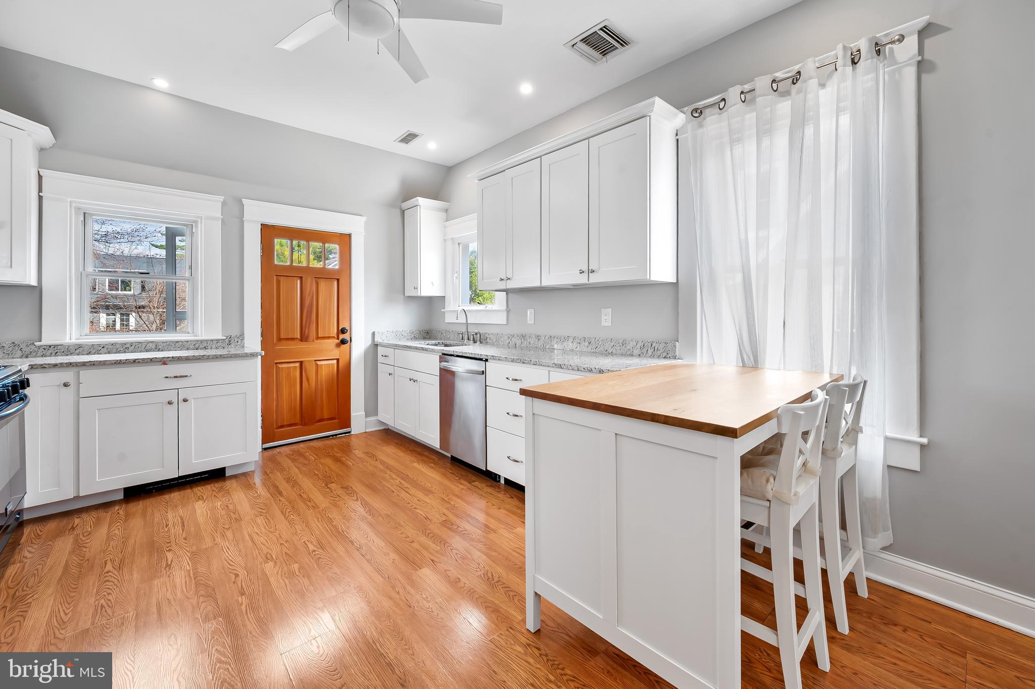 630 Dunkirk Road Baltimore, MD 21212 - Photo 8 of 36 a kitchen with granite countertop a sink cabinets stainless steel appliances and a window