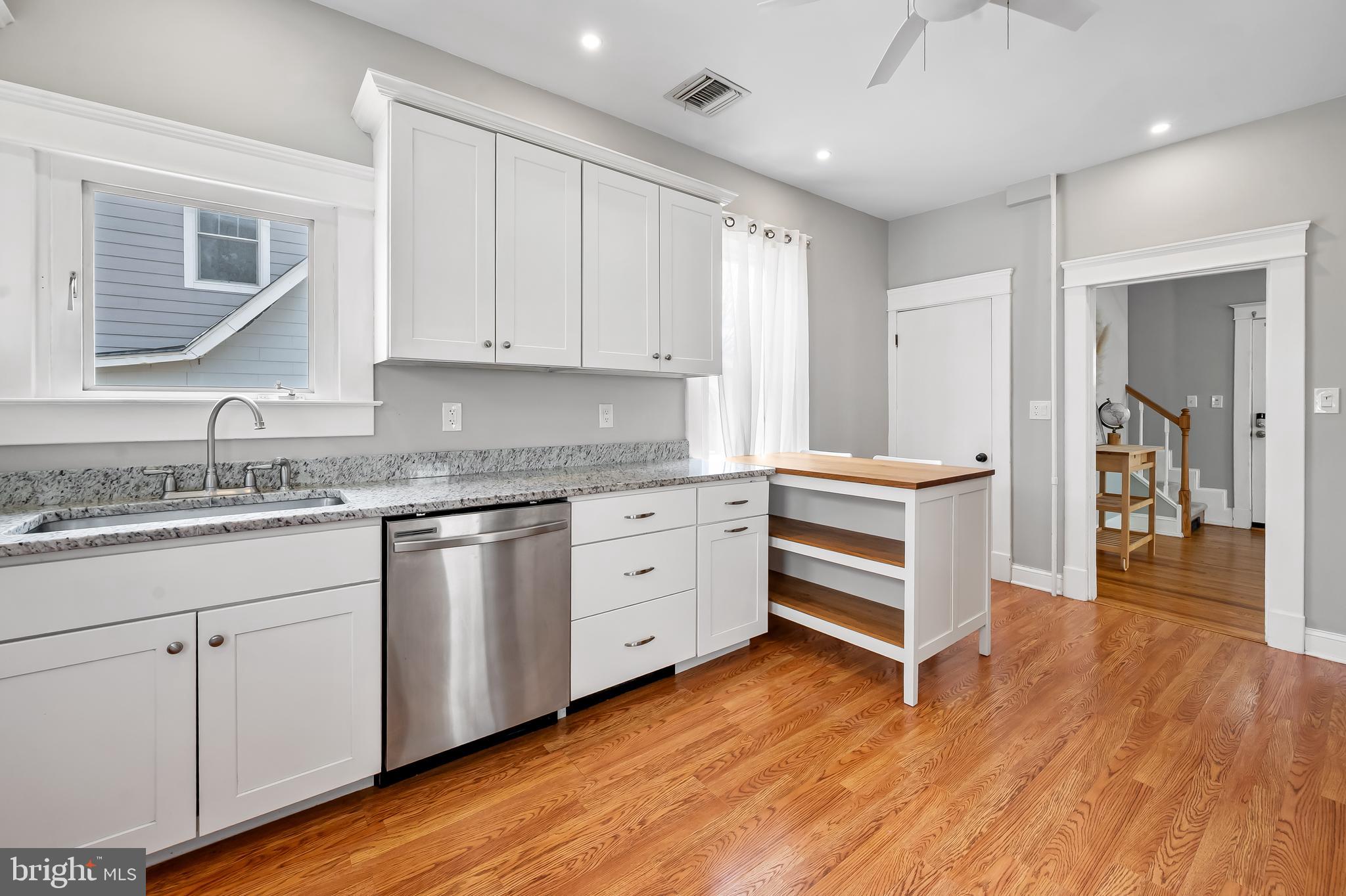 630 Dunkirk Road Baltimore, MD 21212 - Photo 9 of 36 a kitchen with granite countertop a sink cabinets and wooden floor